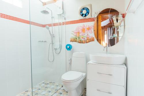 a bathroom with a shower and a toilet and a sink at Thai House Resort in Hua Hin