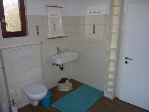 ein kleines Bad mit einem Waschbecken und einem WC in der Unterkunft Ferienhaus Bohlen in Emden