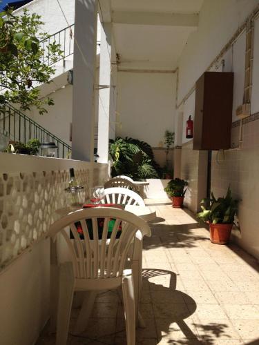 two chairs and a table on a patio at Mértola low-cost in Mértola