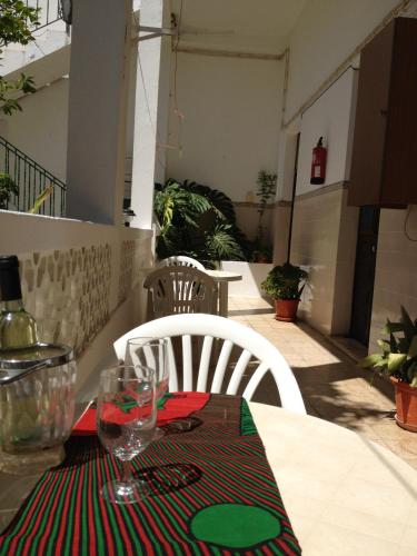 a table with a wine glass on top of it at Mértola low-cost in Mértola