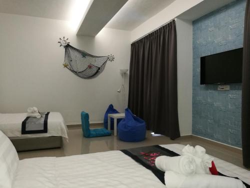 Ένα ή περισσότερα κρεβάτια σε δωμάτιο στο D' Cozy Inn