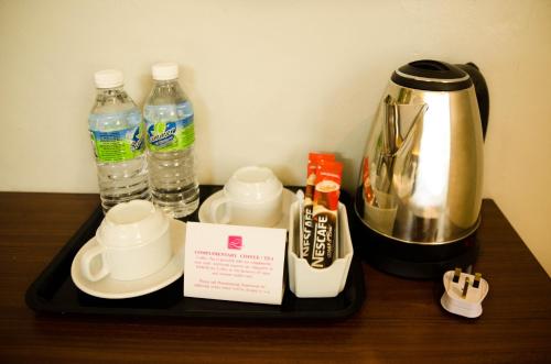 a tray with a coffee maker and bottles of water at Hotel Langkasuka Langkawi in Kuah