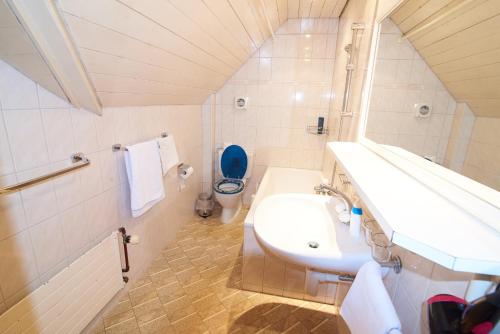 Un baño blanco con lavabo e inodoro. en New West Station 7, en Interlaken