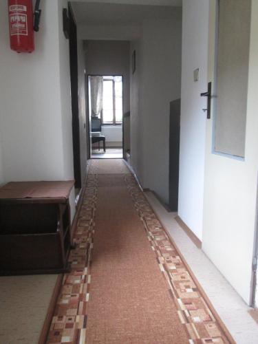 a long hallway with a floor made out of bricks at Penzion U Holubů Nový Jičín in Nový Jičín