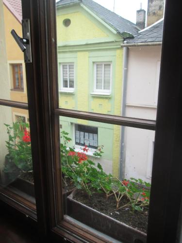 a window with a view of a house at Penzion U Holubů Nový Jičín in Nový Jičín
