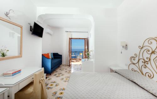 a bedroom with a bed and a view of the ocean at Hotel Pupetto in Positano