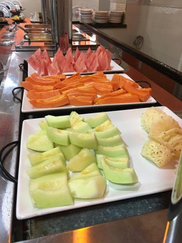 two trays of fruits and vegetables on a counter at Hotel Real Jequie in Jequié