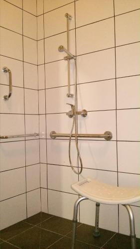 a bathroom with a shower with a table in it at Alma del Camino - Rooms & Albergue in Sarria