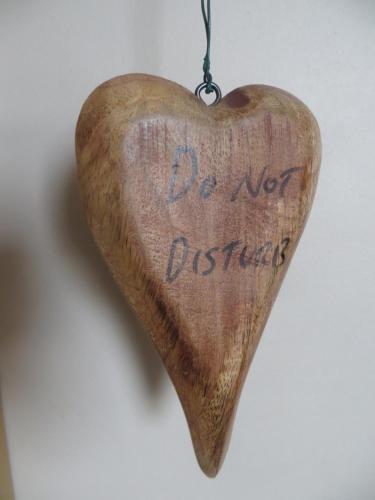 a wooden heart hanging on a wall with the words do not disturb at Moorgarth Guesthouse in York