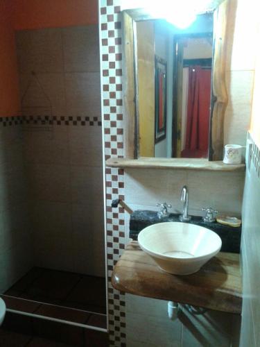 a bathroom with a sink and a mirror and a shower at Estrella del Alma in Capilla del Monte