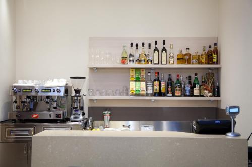 a bar with a lot of bottles of alcohol on shelves at Hotel Ristorante Cesare in Savignano sul Rubicone