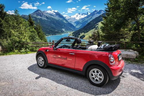 a red car parked on the side of a road at Hotel CENTRAL Bar & Restaurant in Gerlos