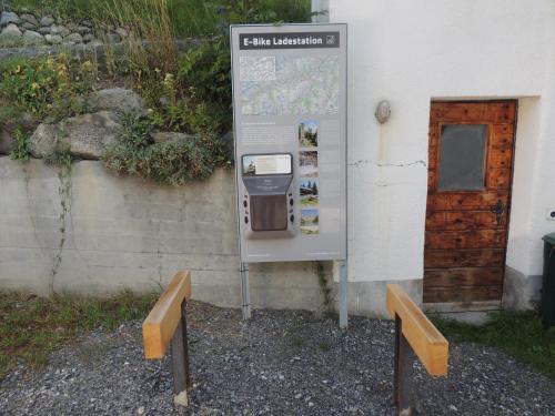 a parking meter sitting next to a building at Hotel Ucliva in Waltensburg