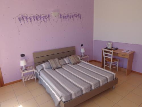Postel nebo postele na pokoji v ubytování La Corte B&B