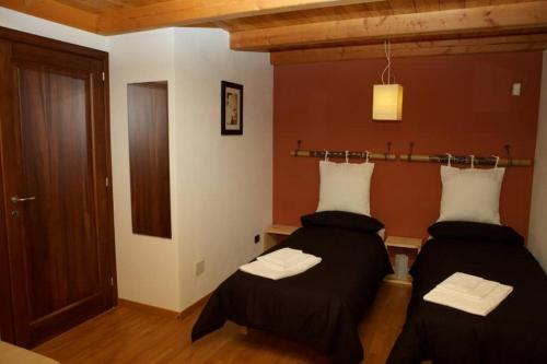 a room with two beds in a room at B&B Casa Val in Quincinetto