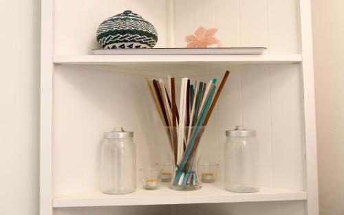 a shelf with glass bottles and other items on it at Il Gamberino in Capraia