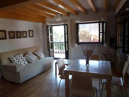 a living room with a couch and a table at Apartamentos Casa de la Abuela in Potes