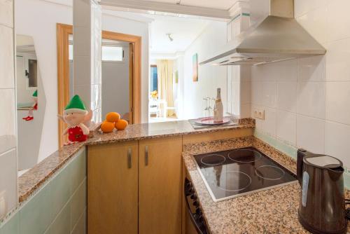 a kitchen with a stove and a counter top at My Pretty Payma Apartamentos in Benidorm