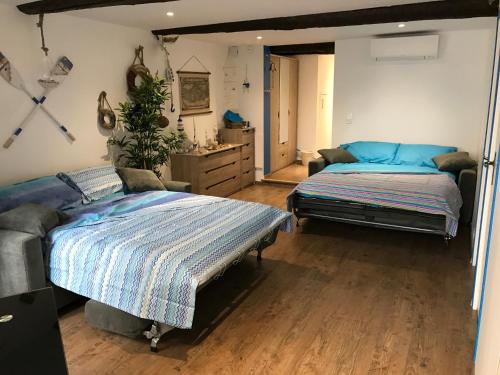 a bedroom with two beds and a dresser at le petit bateau in Menton