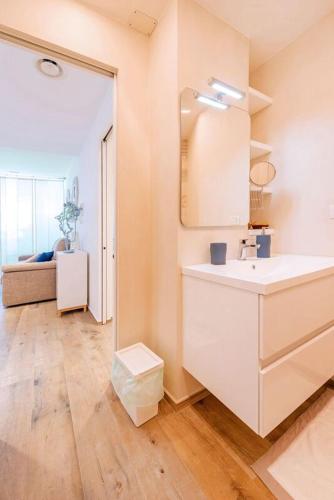 a white bathroom with a sink and a mirror at Dimora Silcla1 in Polignano a Mare