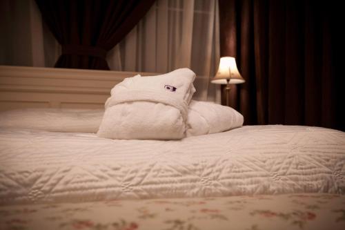 a pile of towels sitting on top of a bed at Villa Joma in Jūrmala