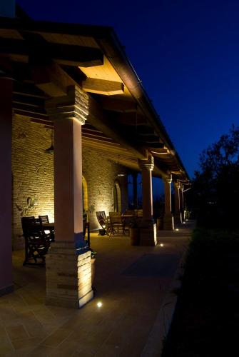 a building with columns and lights on a patio at night at Agriturismo Il Falco in SantʼElpidio a Mare