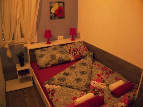 a bed with two pillows on it in a room at Apartmani Mersol Nin in Nin