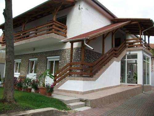 a house with wooden stairs in front of it at Éden II. in Miskolctapolca
