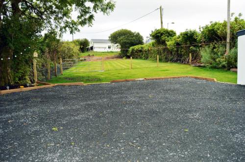 a gravel driveway with a yard in the background at Ash Tree Cottage in Bangor