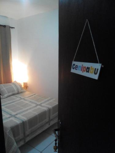 a bedroom with a bed and a sign on the door at Casa do Mochileiro Airport Hostel & Pousada in São Gonçalo do Amarante