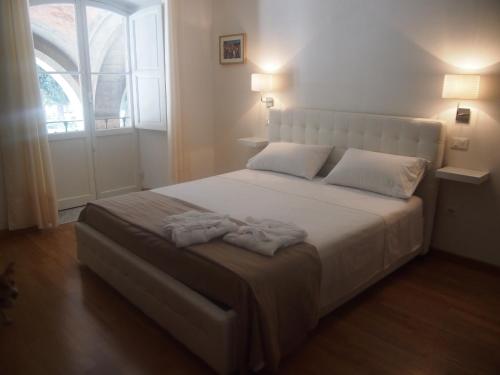 a bedroom with a large bed with two towels on it at IL PORTICO - La Spezia to go 5Terre in La Spezia