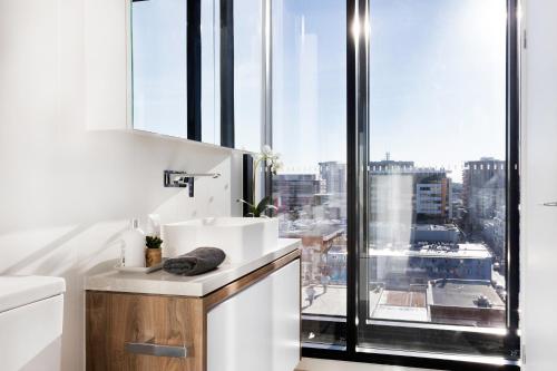 a bathroom with a sink and a large window at FV by Peppers in Brisbane