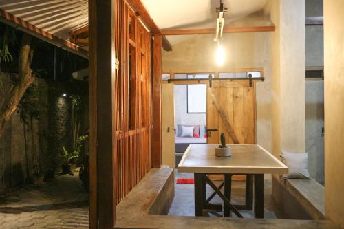 una habitación con una mesa y un banco en ella en Trava House, en Yogyakarta