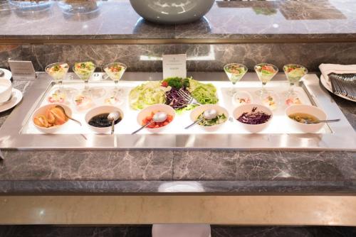 a tray filled with different types of food on a table at GRAMM HOTEL by Ambarrukmo Yogyakarta in Yogyakarta