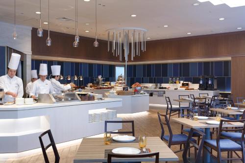 a rendering of a restaurant with chefs preparing food at Palace Hotel Omiya in Saitama