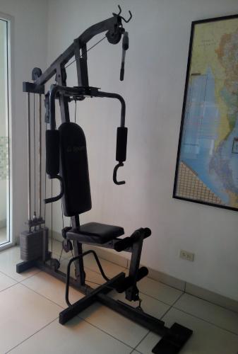 a room with a gym with a squat rack at Jomtien Hostel in Jomtien Beach