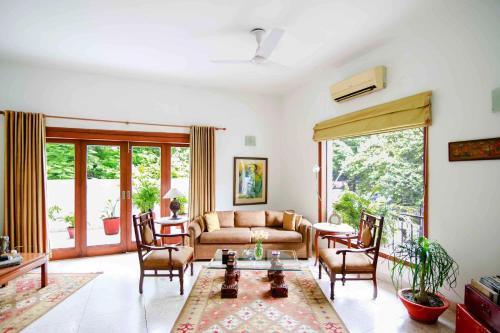 a living room with a couch and a table at Thikana Delhi ( Boutique B&B) in New Delhi