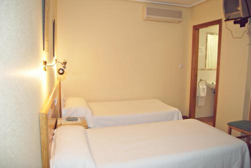 Postel nebo postele na pokoji v ubytování Hotel Los Molinos