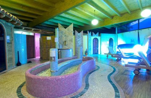 a living room with a large room with a couch and a table at Centro Vacanze La Limonaia in Limone sul Garda