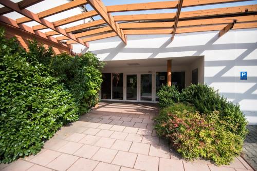 an outside view of a building with a wooden roof at Apartmány Tiva in Ostrava
