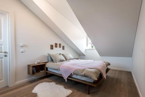 ein Schlafzimmer mit einem Bett im Dachgeschoss in der Unterkunft Angel House Vilnius 40 in Vilnius