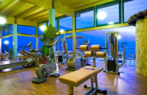 a gym with several exercise equipment in a room at Centro Vacanze La Limonaia in Limone sul Garda