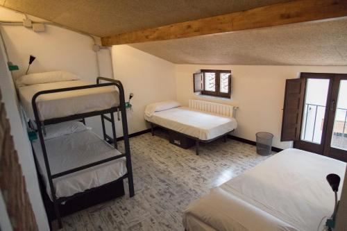 a room with two bunk beds in a room at Green River Hostel in Cuenca