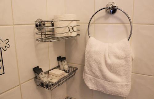 a towel hanging on a rack in a bathroom at The Parkway Hotel in Dunmanway