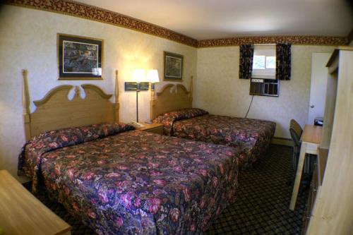 a hotel room with two beds in a room at Appalachian Motel in Vernon
