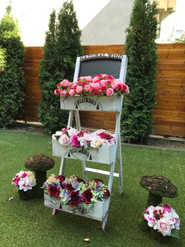 a white chair with flowers on top of it at Villa Nina Hotel & Lounge bar in Skopje