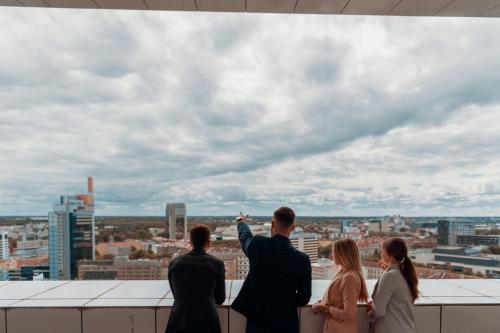a group of people standing on a roof looking at a city at Original Sokos Hotel Viru in Tallinn