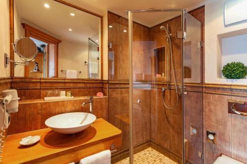 a bathroom with a sink and a shower at Hotel Leeberghof in Tegernsee