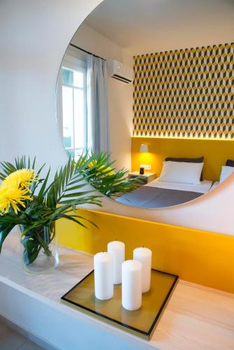 a bedroom with a bed and a mirror at Sunshine Studios in Malia