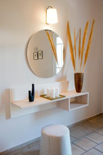 a bathroom with a mirror and a stool at Sunshine Studios in Malia